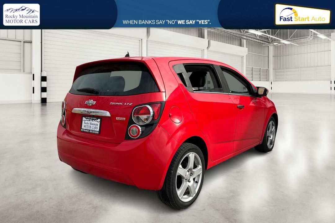 2015 Red Chevrolet Sonic LTZ Auto 5-Door (1G1JE6SB1F4) with an 1.4L L4 DOHC 24V TURBO engine, 6-Speed Automatic transmission, located at 767 S State Road, Pleasant Grove, UT, 84062, (801) 785-1058, 40.354839, -111.736687 - Photo#2