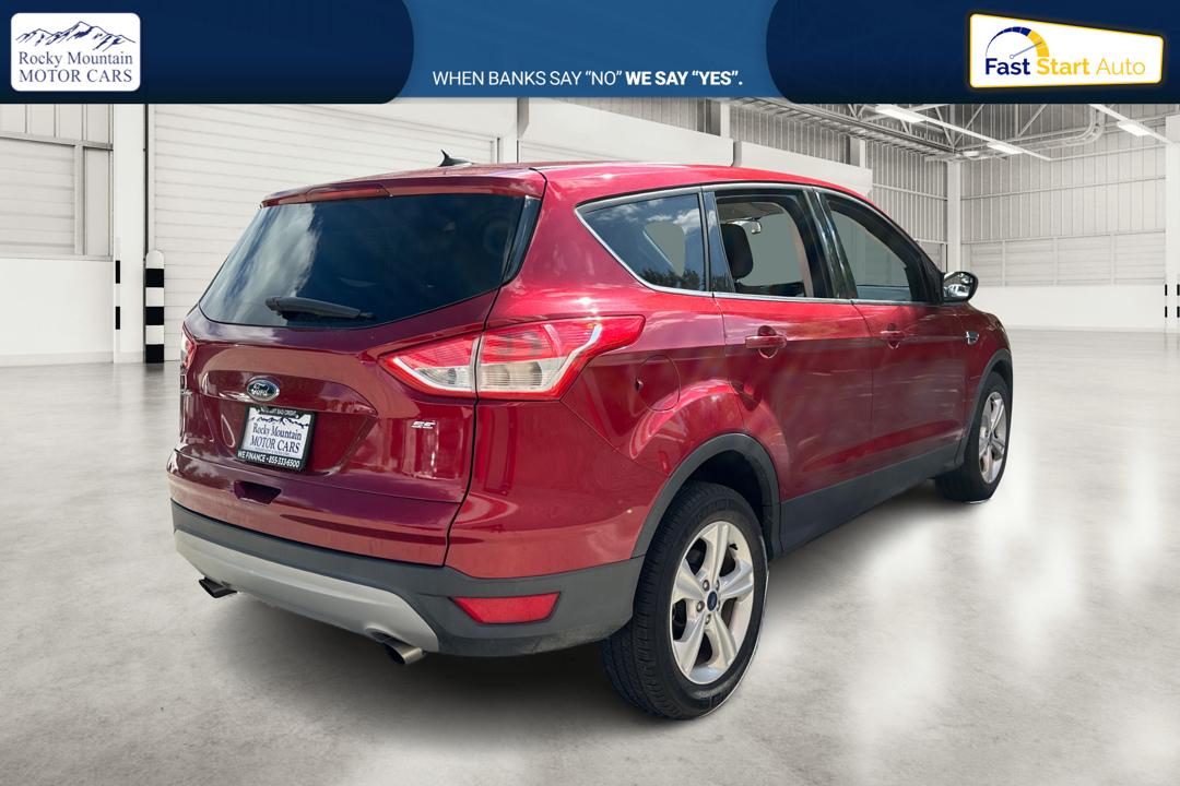 2016 Red Ford Escape SE FWD (1FMCU0G79GU) with an 2.5L L4 DOHC 16V engine, 6-Speed Automatic transmission, located at 767 S State Road, Pleasant Grove, UT, 84062, (801) 785-1058, 40.354839, -111.736687 - Photo#2