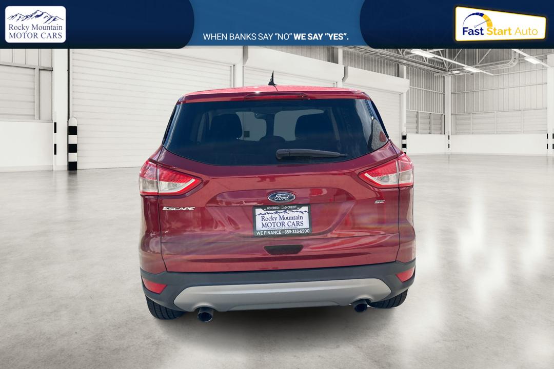 2016 Red Ford Escape SE FWD (1FMCU0G79GU) with an 2.5L L4 DOHC 16V engine, 6-Speed Automatic transmission, located at 767 S State Road, Pleasant Grove, UT, 84062, (801) 785-1058, 40.354839, -111.736687 - Photo#4
