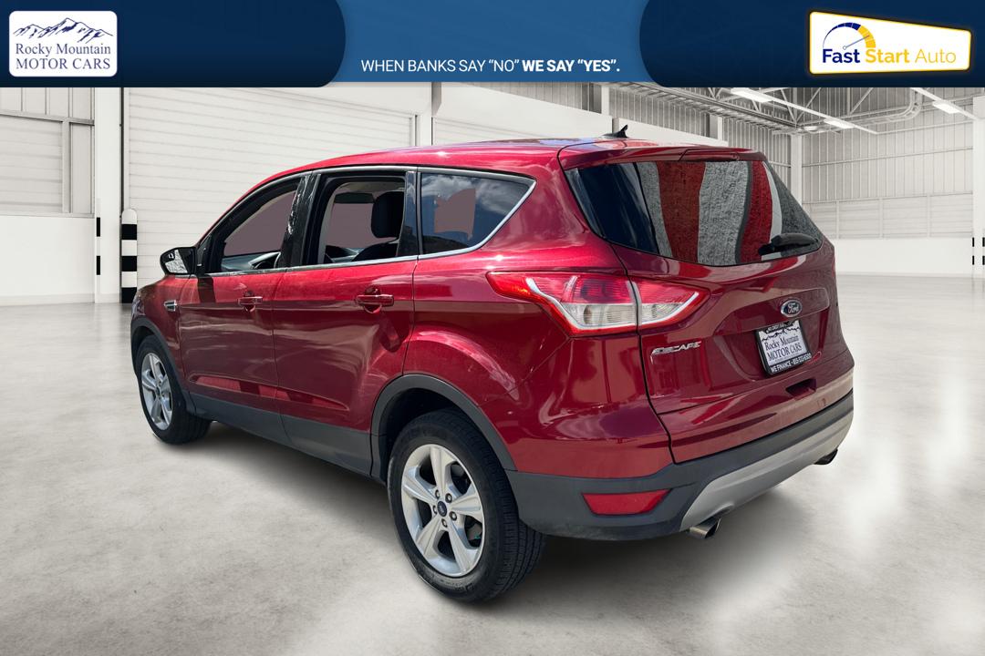 2016 Red Ford Escape SE FWD (1FMCU0G79GU) with an 2.5L L4 DOHC 16V engine, 6-Speed Automatic transmission, located at 767 S State Road, Pleasant Grove, UT, 84062, (801) 785-1058, 40.354839, -111.736687 - Photo#5