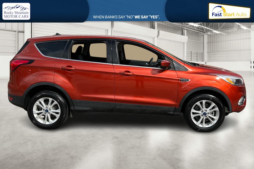 2019 Orange Ford Escape SE 4WD (1FMCU9GD0KU) with an 1.5L L4 DOHC 16V engine, 6A transmission, located at 767 S State Road, Pleasant Grove, UT, 84062, (801) 785-1058, 40.354839, -111.736687 - Photo #1