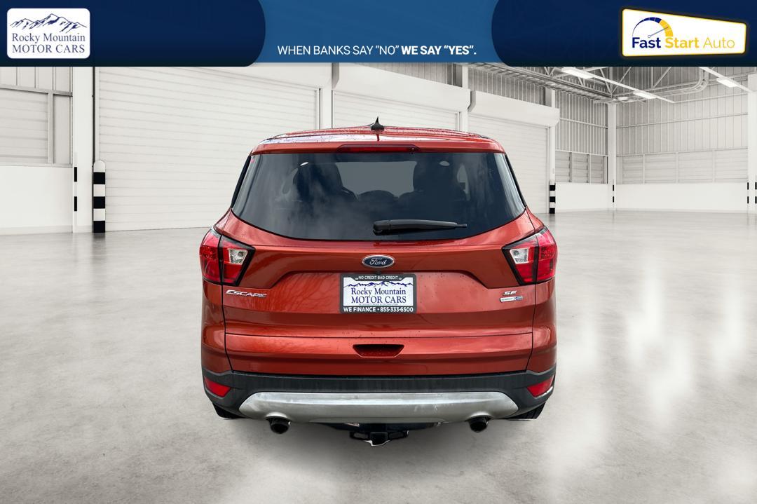 2019 Orange Ford Escape SE 4WD (1FMCU9GD0KU) with an 1.5L L4 DOHC 16V engine, 6A transmission, located at 767 S State Road, Pleasant Grove, UT, 84062, (801) 785-1058, 40.354839, -111.736687 - Photo #3