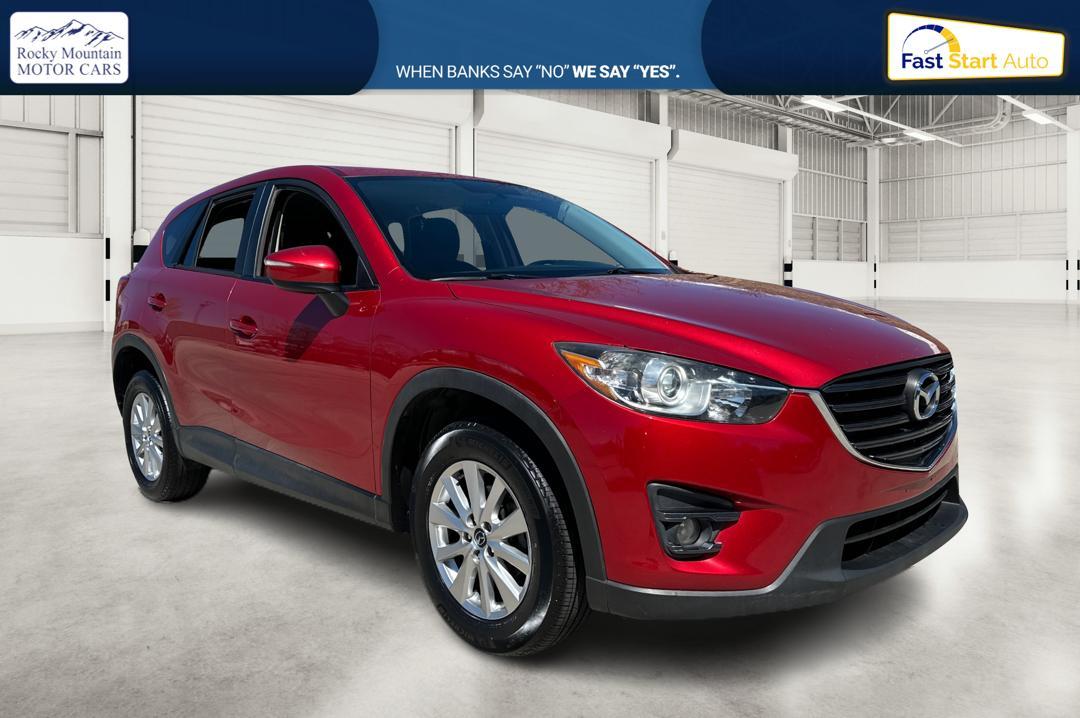 2016 Red Mazda CX-5 Touring (JM3KE2CY0G0) with an 2.5L L4 DOHC 16V engine, 6-Speed Automatic transmission, located at 767 S State Road, Pleasant Grove, UT, 84062, (801) 785-1058, 40.354839, -111.736687 - Photo #0