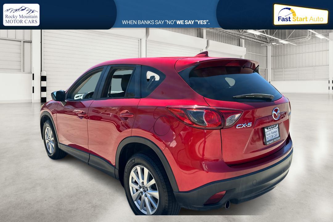2016 Red Mazda CX-5 Touring (JM3KE2CY0G0) with an 2.5L L4 DOHC 16V engine, 6-Speed Automatic transmission, located at 767 S State Road, Pleasant Grove, UT, 84062, (801) 785-1058, 40.354839, -111.736687 - Photo #4