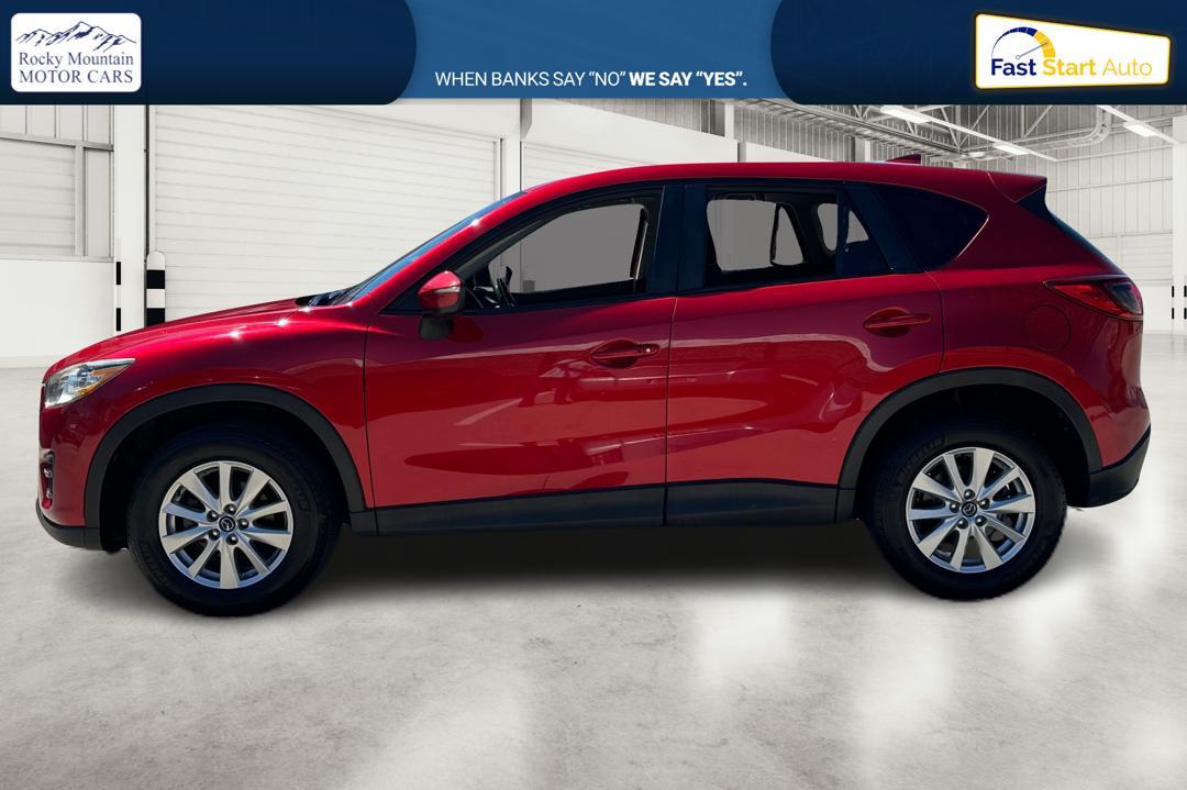 2016 Red Mazda CX-5 Touring (JM3KE2CY0G0) with an 2.5L L4 DOHC 16V engine, 6-Speed Automatic transmission, located at 767 S State Road, Pleasant Grove, UT, 84062, (801) 785-1058, 40.354839, -111.736687 - Photo #5